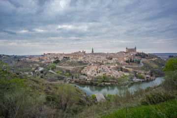 Fototapeta na wymiar Wide angle view of Toledo with cloudy sky at sunset