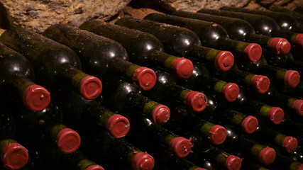 stacked up wine bottles in the cellar