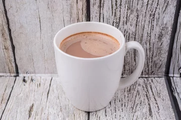 Foto op Plexiglas Chocolade A mug of hot chocolate over wooden background