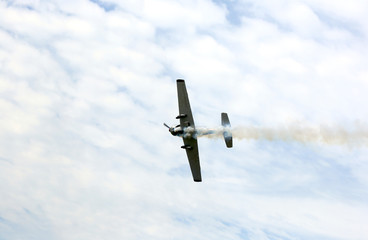 historic warplane with dark smoke from the engine malfunction