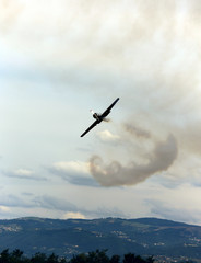 Fototapeta na wymiar historic warplane with dark smoke from the engine malfunction