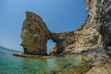 Unique and scenic arch in the cliffs, Paxi, Greece