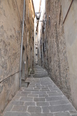 Narrow stony street in Tuscany town Italy
