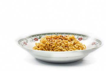 instant fried noodles in plate isolated on white background.