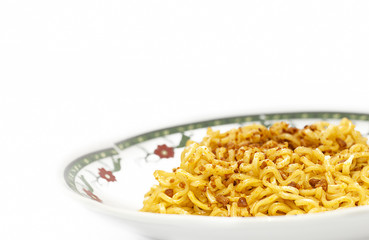 Close up shot on instant fried noodles in plate isolated on whit