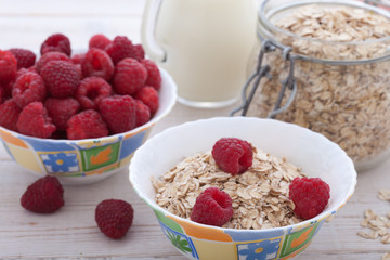 Berries, fruit, milk and muesli Ingredients for healthy breakfast on wooden table
