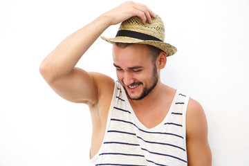 Young man with beard and hat laughing