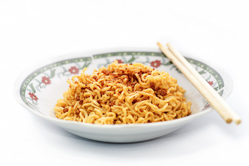 instant fried noodles in plate isolated on white background.