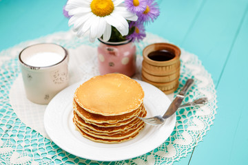 Stack of pancakes on wooden background