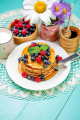 Stack of pancakes on wooden background