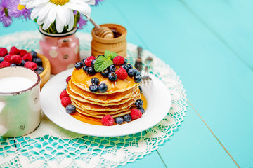 Stack of pancakes on wooden background