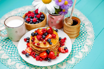 Stack of pancakes on wooden background
