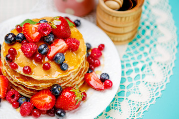 Stack of pancakes on wooden background