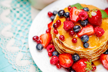 Stack of pancakes on wooden background