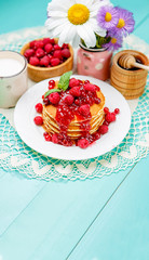 Stack of pancakes on wooden background