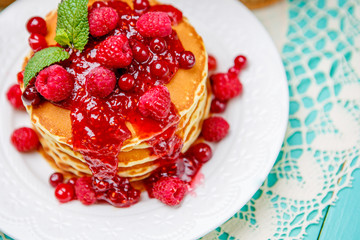 Stack of pancakes on wooden background