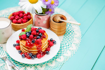 Stack of pancakes on wooden background