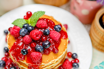 Stack of pancakes on wooden background
