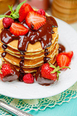 Stack of pancakes on wooden background