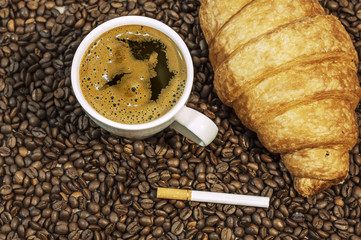 Coffee bean background with cup of fresh hot coffee, cigar and c