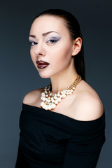 Beautiful female model posing in jewelry necklace