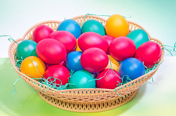 Colored easter romanian traditional eggs in a brown basket, close up, macro.