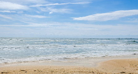 The Black Sea beach with sand and water, blue sky clouds, seaside