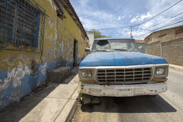 Old vintage car with broken window in the street of Margarita Is