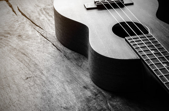 Close up of ukulele on old wood background with soft light