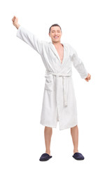 Young guy in a white bathrobe stretching himself