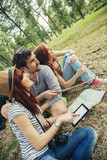 Group Of Tourists In Nature Using Map