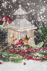 Fototapeta na wymiar Christmas decoration and burning vintage lantern in snow