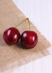 Fresh cherries on white wooden table, healthy food