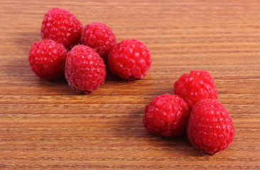 Fresh raspberries on wooden surface, healthy food