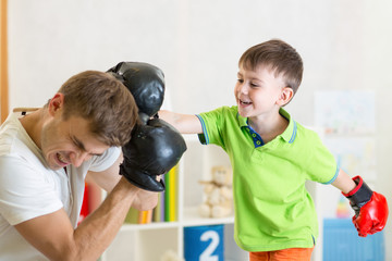 child and dad play boxing