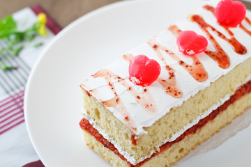 Strawberry cake with heart candies for sweet valentines.
