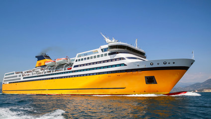 Big yellow passenger ferry goes on the Sea