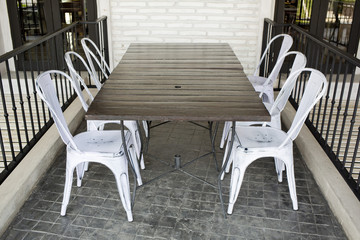 Fototapeta na wymiar white plastic chairs on brick block ground at restaurant terrace