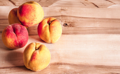 fresh peaches on wooden table