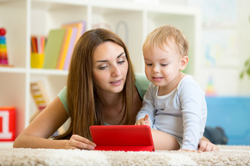 mother and son child play with tablet pc