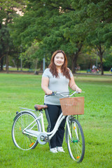 Happy woman posing with bicycle