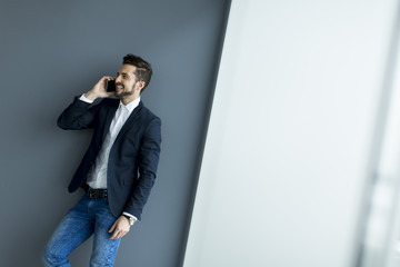 Young man with mobile phone in the office