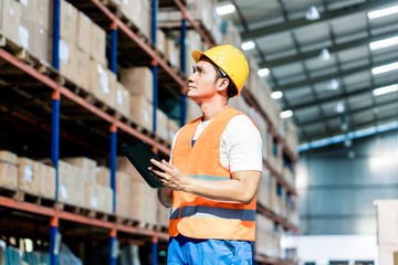 Worker taking inventory in logistics warehouse