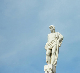 Fototapeta na wymiar Statue on top of Milan Duomo roof spire.