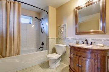 Gorgeous bathroom with tan shower curtain.