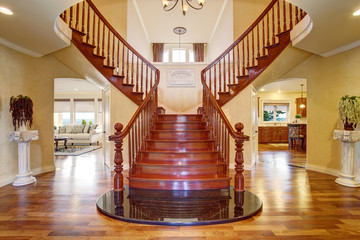 Elegant double staircase with a chandelier.