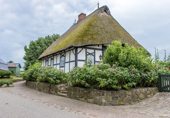 Fototapeta na wymiar Thatched House / old half-timbered house with thatched roof 