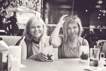 two women  in outdoor cafe