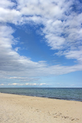 Fototapeta na wymiar Coast / Baltic Sea beach with blue sky and white clouds