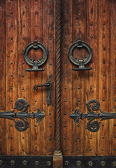 Old carved wooden door with hinges